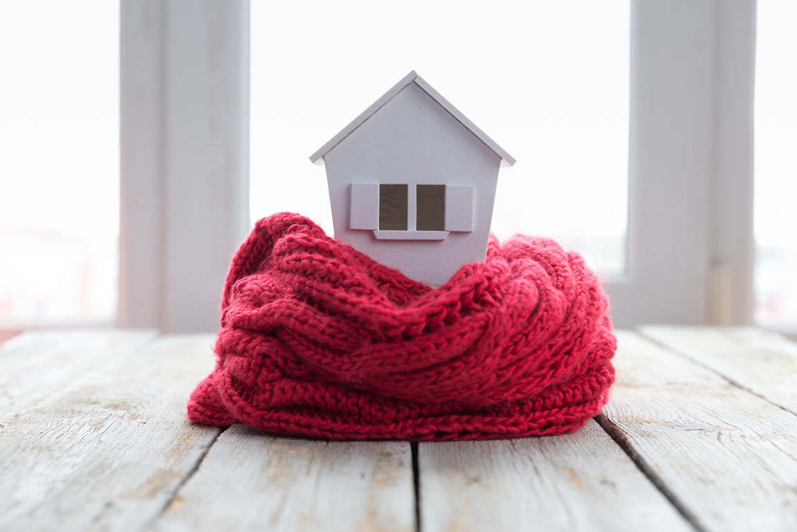 red quilt wrapped around model house