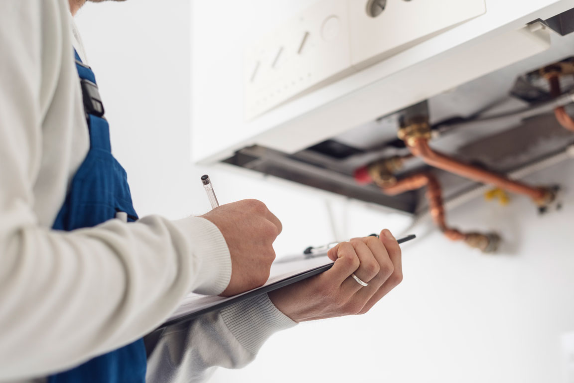 man evaluating pipes in a home inspection