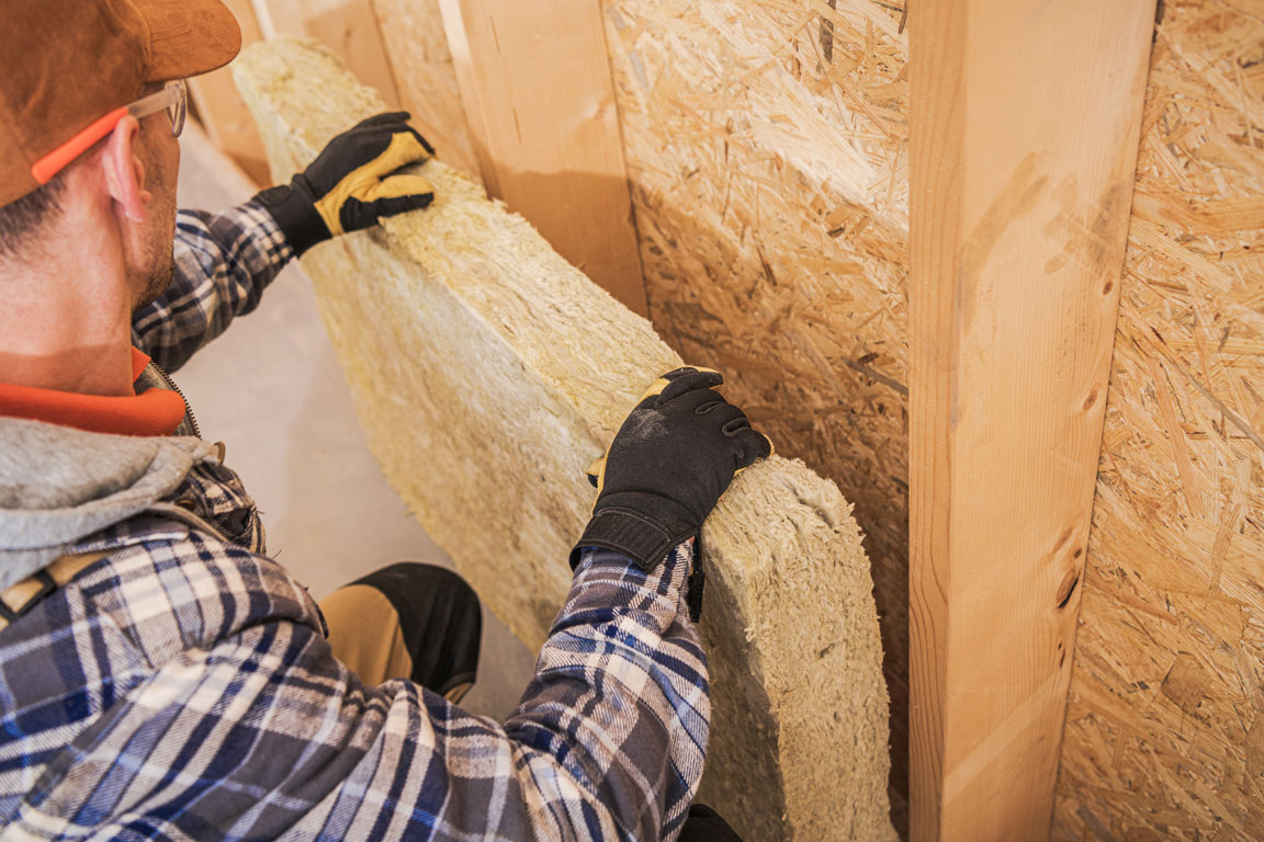 contractor installing insulation