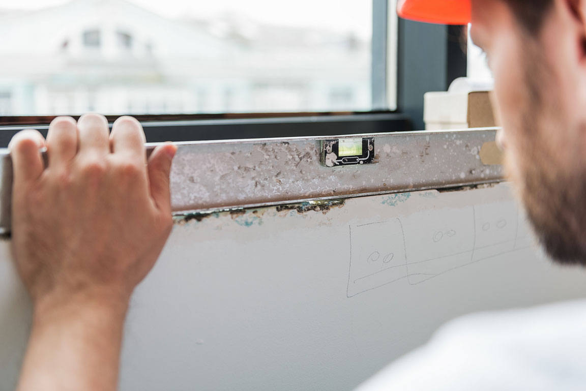 construction worker measuring window