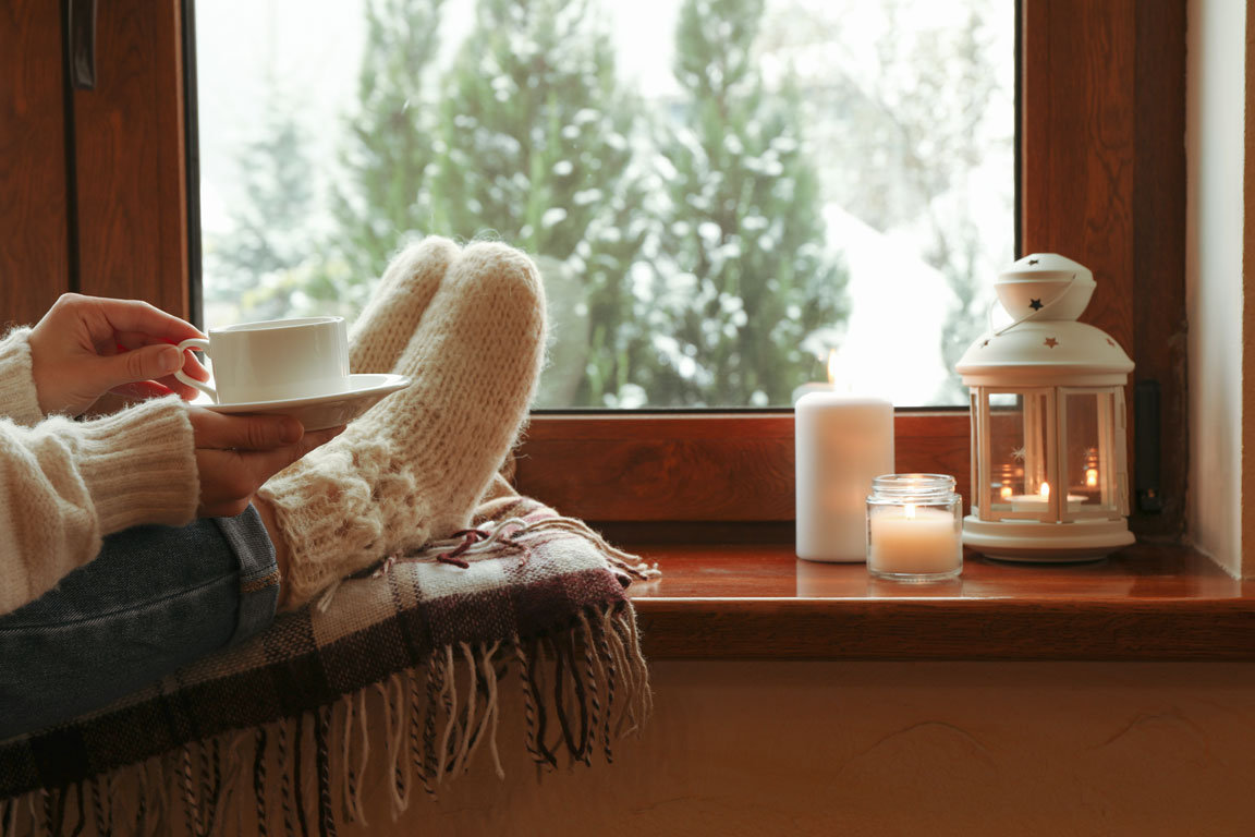 warm socks and a cup of tea by the window after a snow storm