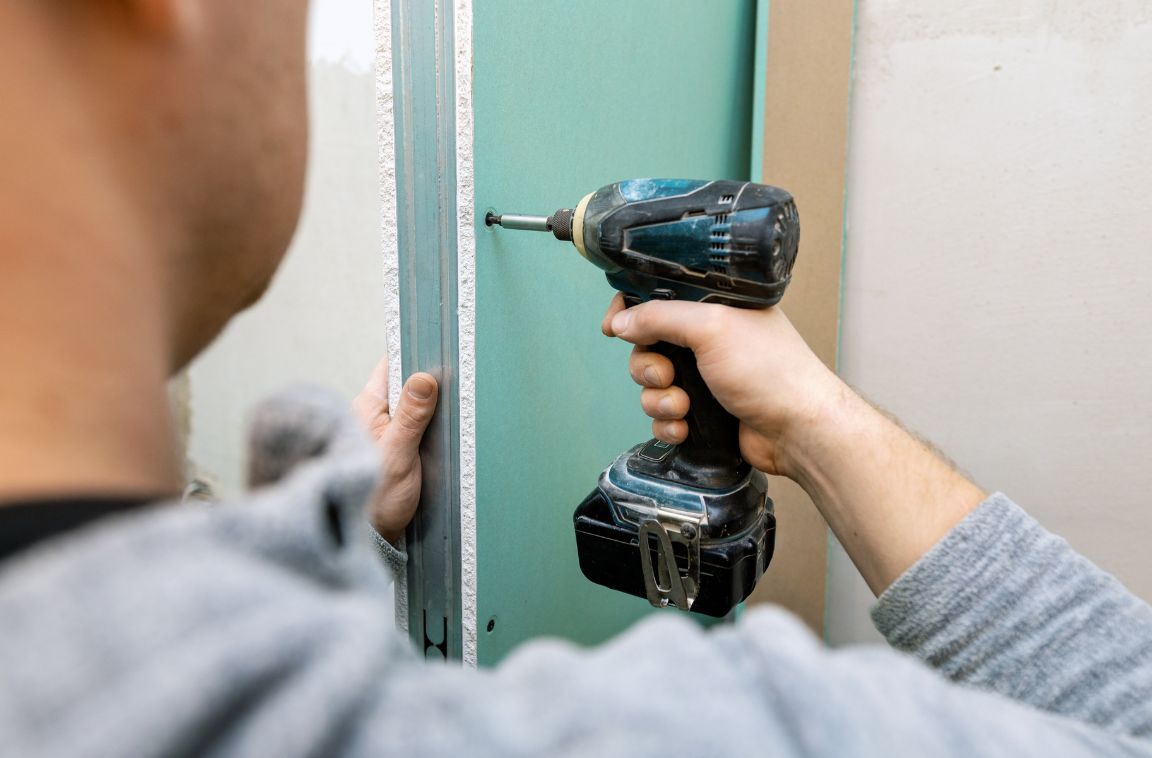 person installing fire resistant drywall