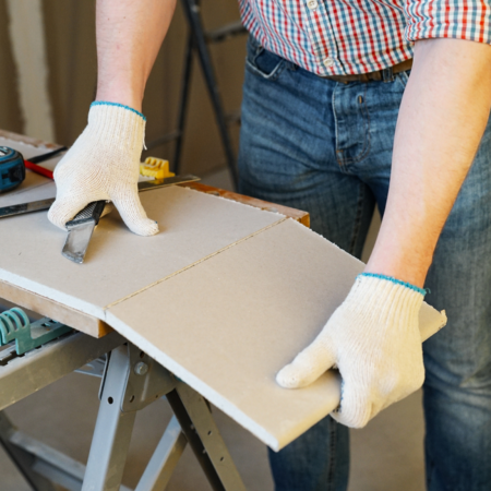 man cutting drywall