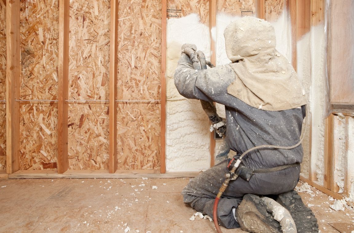 insulation expert installing spray foam installation in a home
