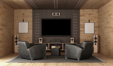 Chairs positioned in front of many sound system speakers