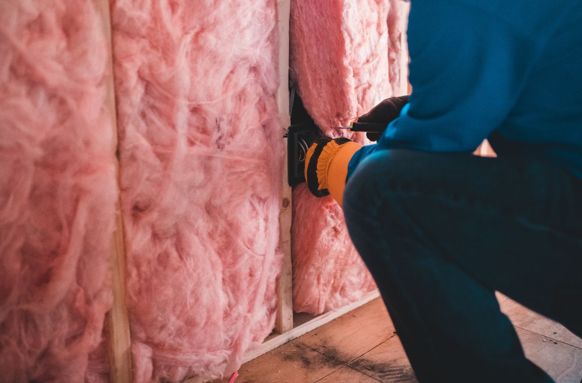 an insulation expert installing batt fiberglass